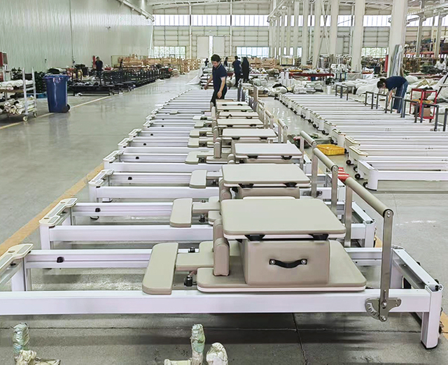Agbfitness factory workers assembling Megaformer machines