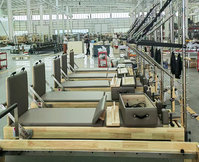 Skilled workers crafting Pilates machines at Agbfitness